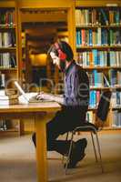 Hipster student studying in library
