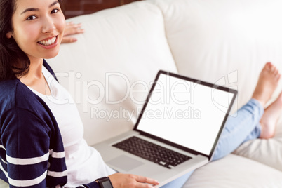 Asian woman on the couch using laptop Asian woman on the couch using laptop
