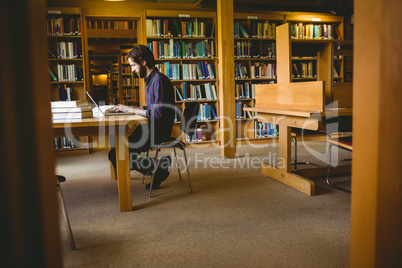 Hipster student studying in library