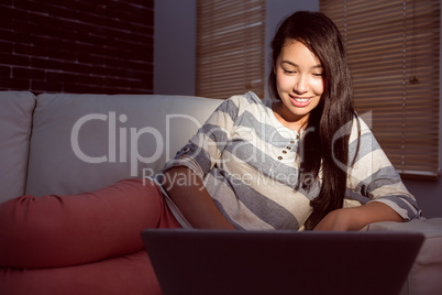 Asian woman using laptop at night