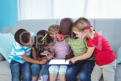 Happy kids using technology while sitting