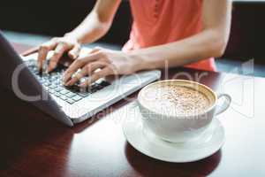 Mature student using laptop in cafe