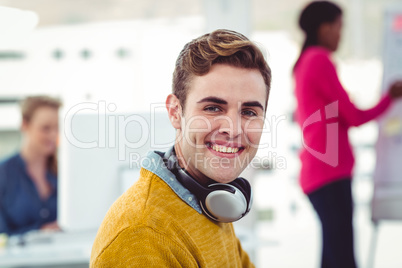Graphic designer wearing headphones at desk
