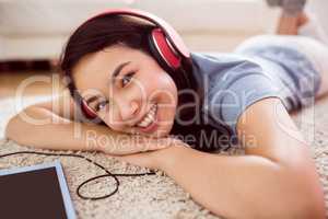 Asian woman using tablet on floor