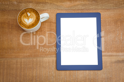 Above view of a coffee and a blue tablet