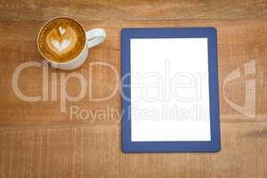 Above view of a coffee and a blue tablet