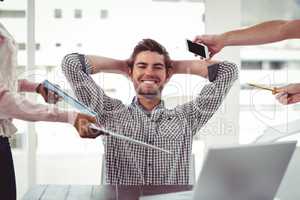 Smiling businessman being handed items