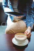 Mature student using tablet in cafe