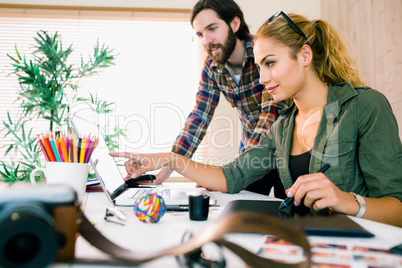 Creative team working at desk with laptop