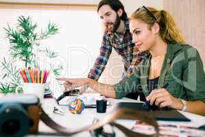 Creative team working at desk with laptop