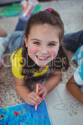 Smiling kids drawing pictures on paper