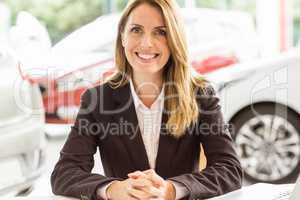 Smiling saleswoman working at her desk