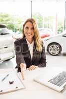 Smiling saleswoman ready to shake hand