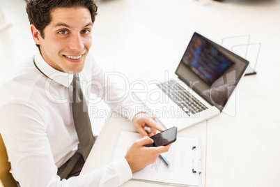 Smiling salesman having a phone call