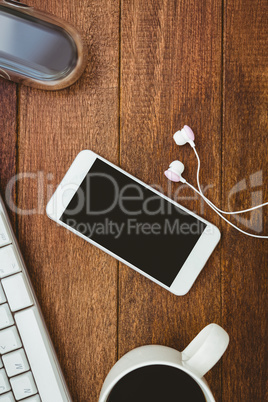 White smartphone with cup of coffee