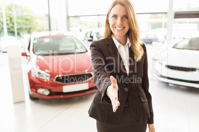 Smiling businesswoman reaching her hand