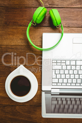 View of a grey laptop with a green headphone