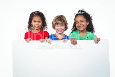 Three kids holding a large white sheet