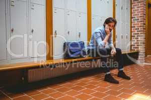 Hipster student feeling sad in hallway