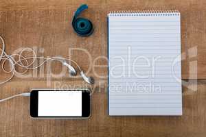 Notepad with smartphone and measuring tape