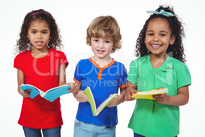 Three kids standing with books in their hands