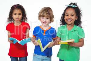 Three kids standing with books in their hands