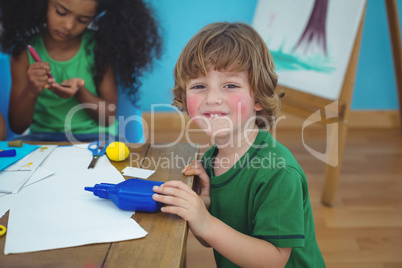Small boy using arts and crafts supplies