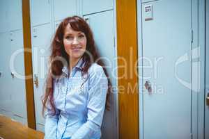 Mature student smiling at camera in hallway