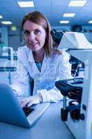 Scientist working with a laptop in laboratory