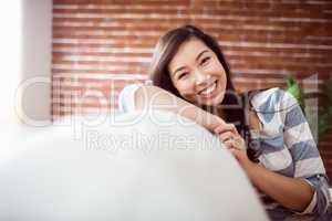 Smiling asian woman on couch