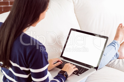 Asian woman on the couch using laptop