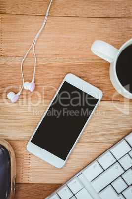 White smartphone with cup of coffee