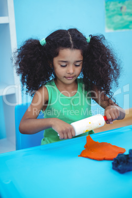 Smiling girl using modelling clay