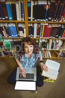 Mature student in library using laptop