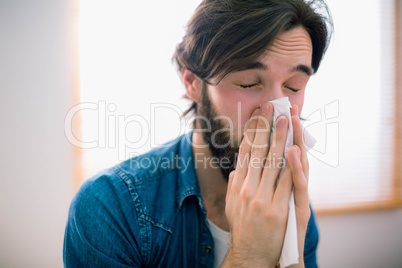 Sick man blowing his nose