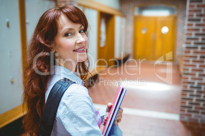 Mature student opening her locker