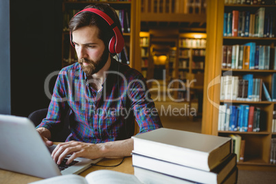 Hipster student studying in library