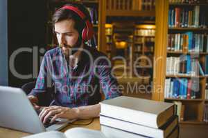 Hipster student studying in library