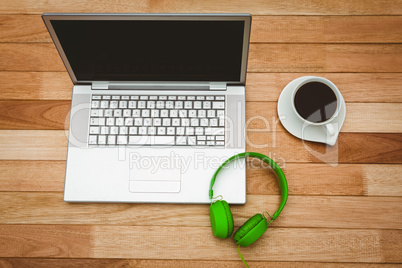 View of a grey laptop with a green headphone