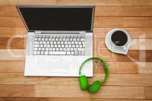 View of a grey laptop with a green headphone
