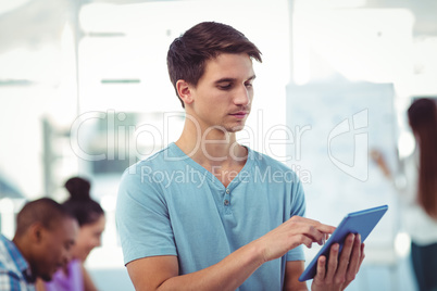 Young creative worker using tablet