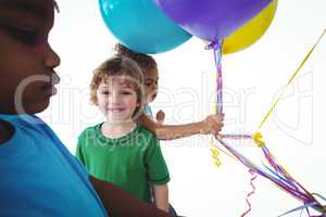 Group of kids together with balloons