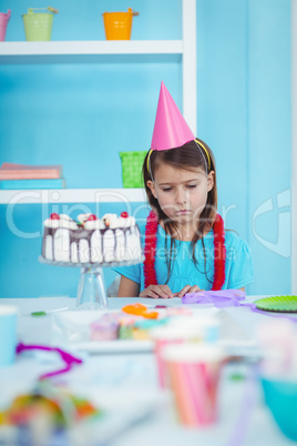 Sad kid alone at her birthday