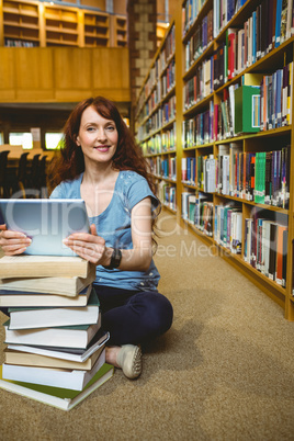 Mature student in library using tablet