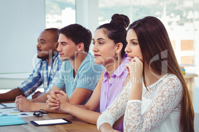 Creative business team listening at meeting