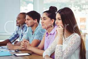 Creative business team listening at meeting