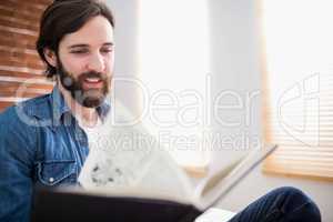 Casual man reading on his sofa