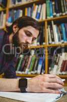 Student studying on floor in library wearing smart watch