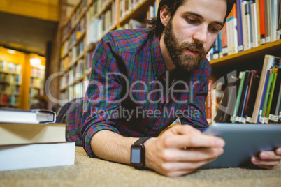 Student studying on floor in library wearing smart watch