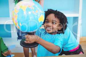 Small boy holding a globe of the world
